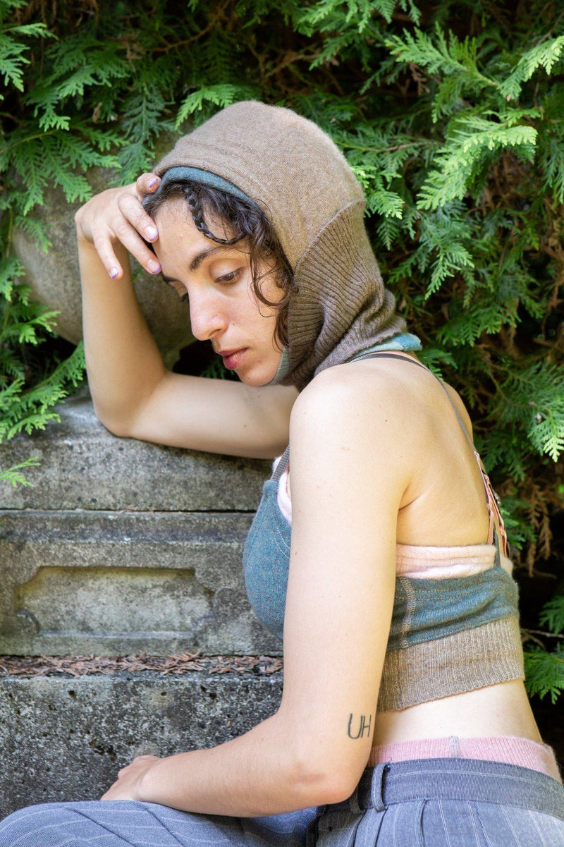 model wearing brown and green cashmere balaclava, bralette and undie