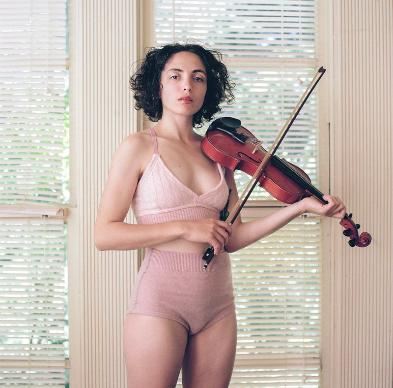 model wearing pink cashmere bralette and undie