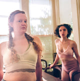 two models each wearing green and pink cashmere bralette and undie