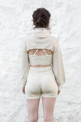 model wearing ivory cashmere bolero, bralette and undie