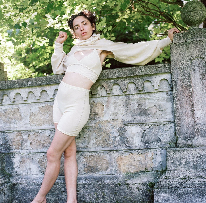 model wearing ivory cashmere bolero, bralette and undie